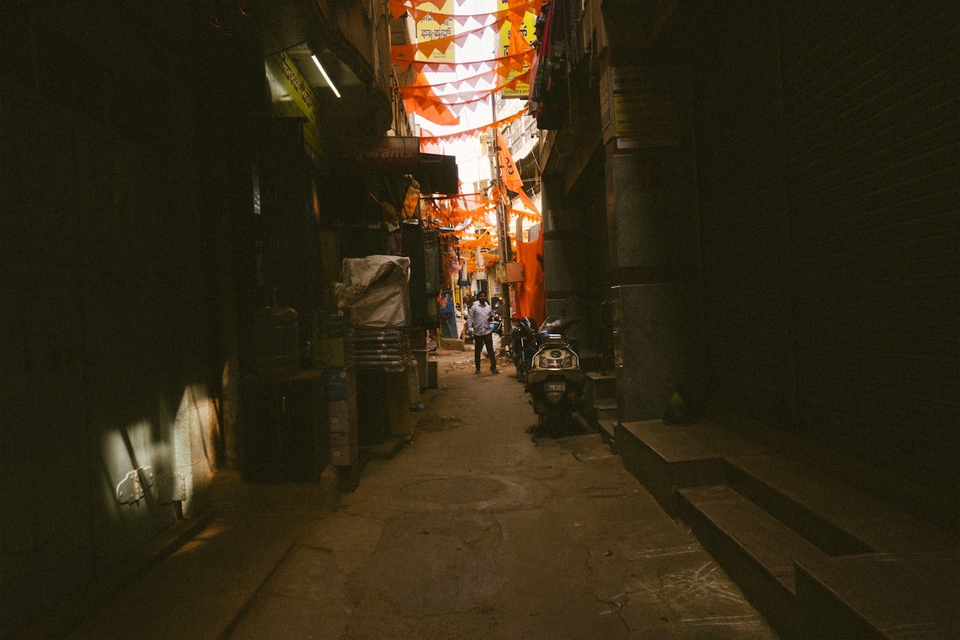 A narrow alleyway decorated with colourful flags