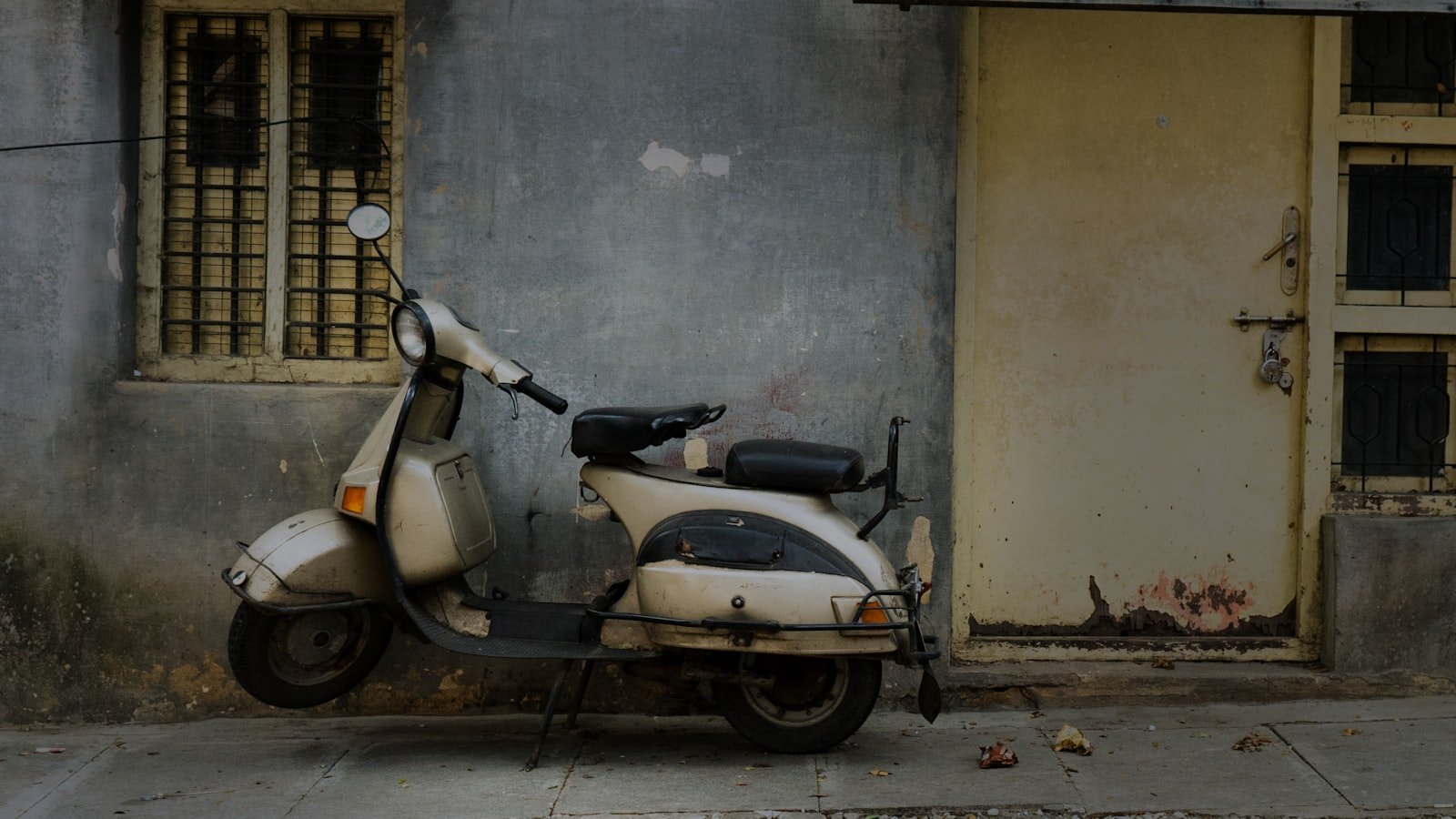 A motor scooter parked in front of a building