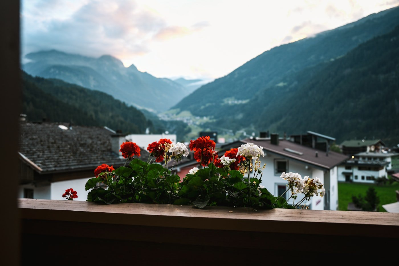 A window looking out over mountains and houses